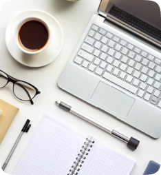 Workspace with laptop, coffee, and notebook